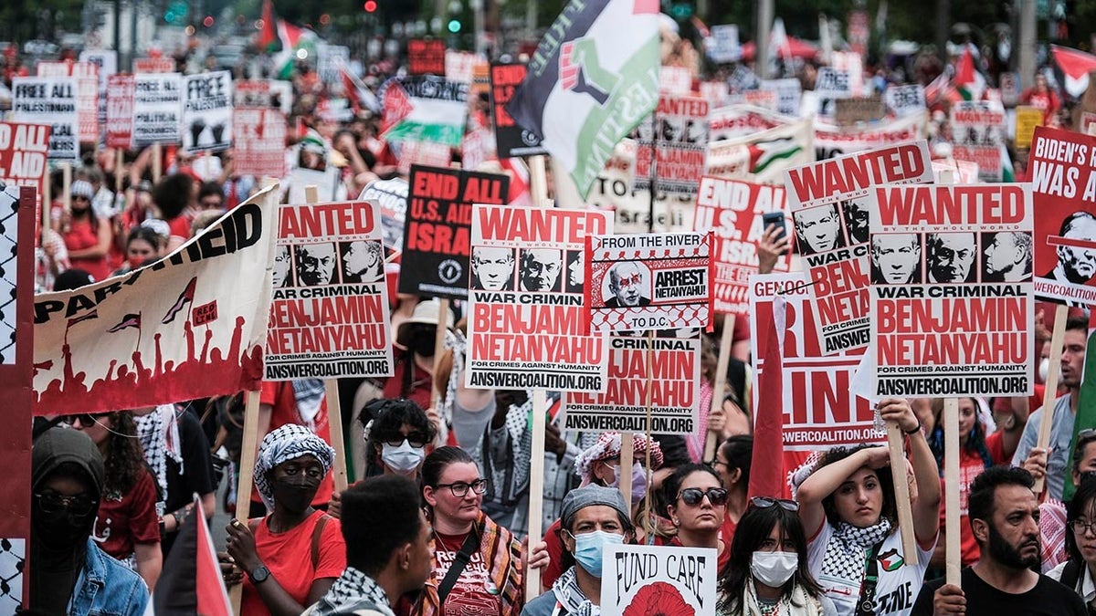 Protesters holding up signs