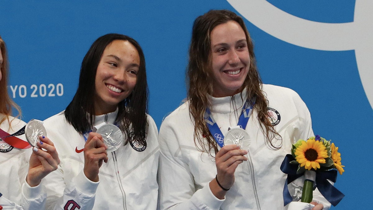 Torri Huske and Abbey Weitzeil posing with medals in Tokyo.