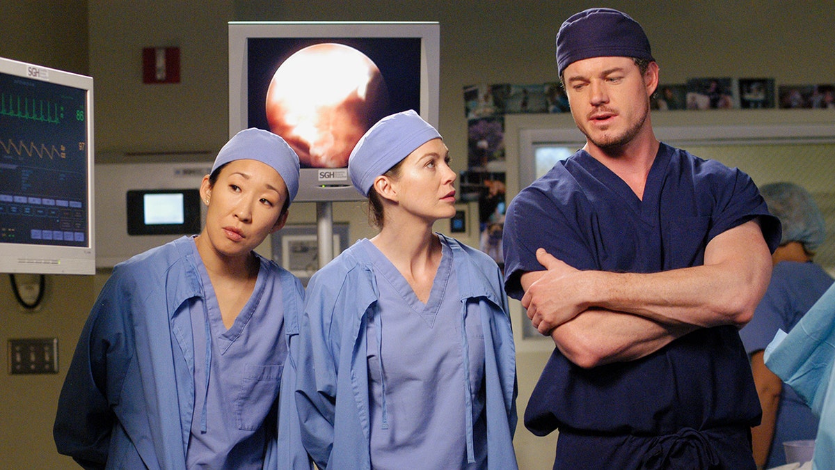 Eric Dane, Ellen Pompeo and Sandra Oh in scrubs on the set of "Greys Anatomy"