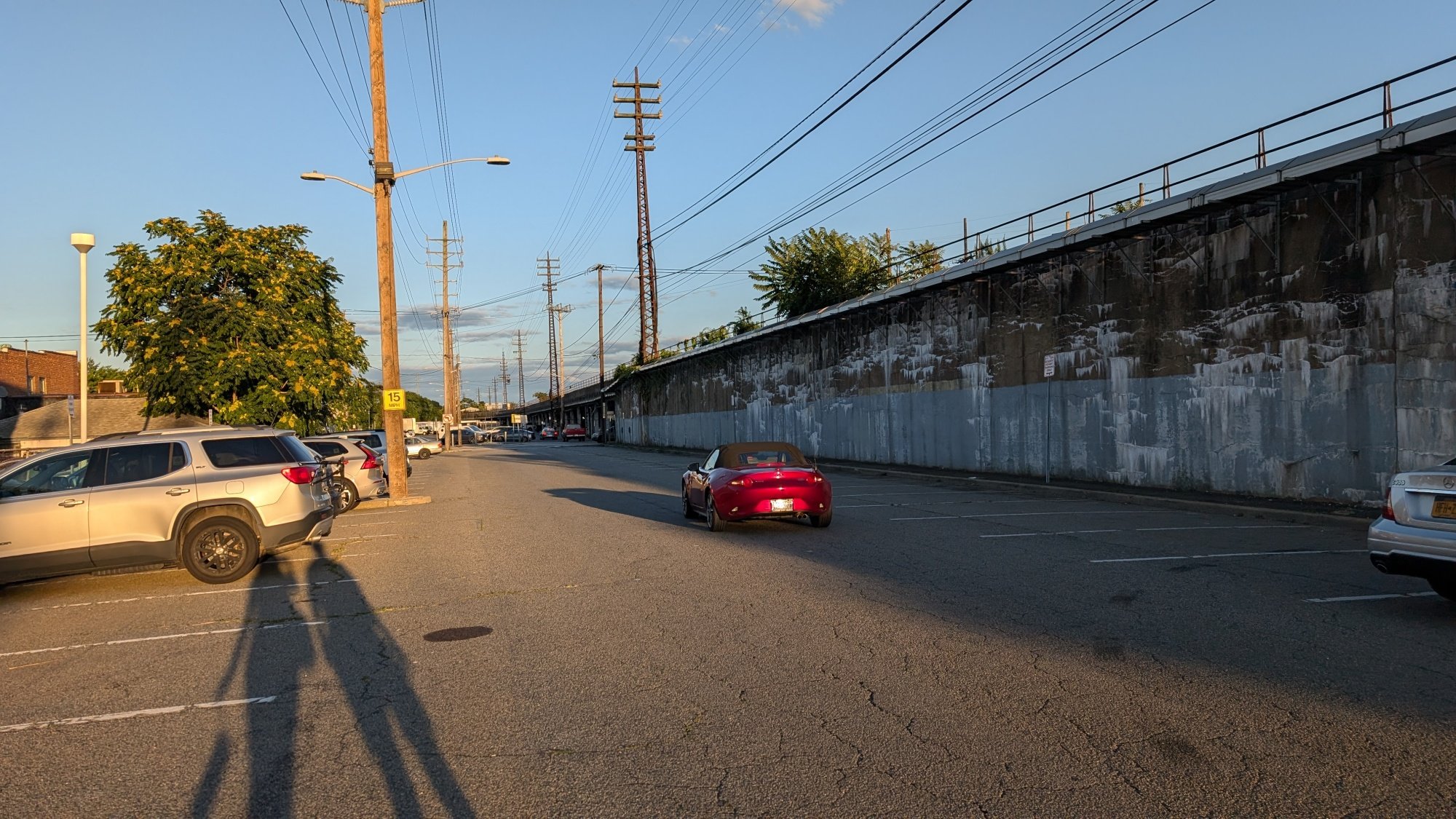 A red car in a parking lot in Long Island