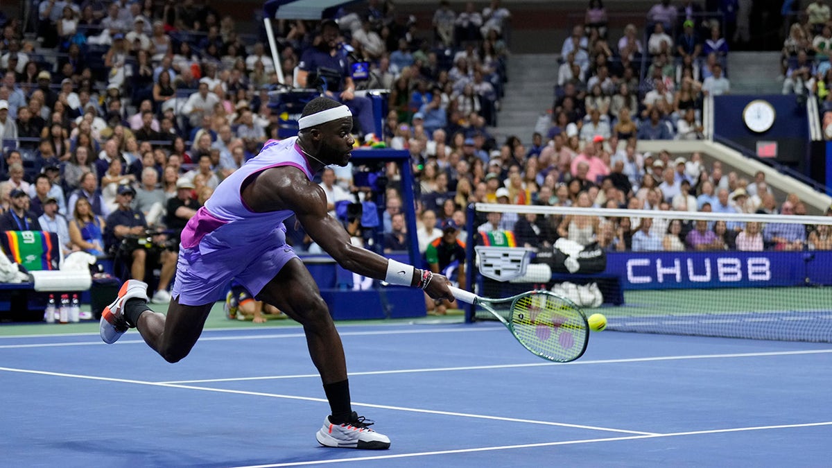 Frances Tiafoe wearing purple