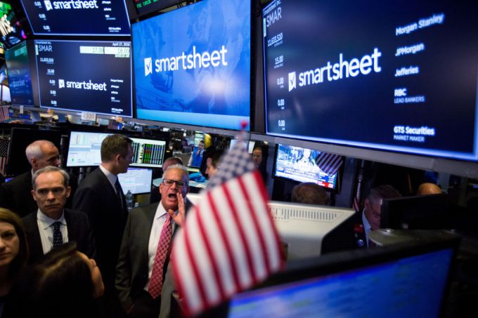 Traders work below monitors displaying Smartsheet.com Inc. signage during its 2018 IPO