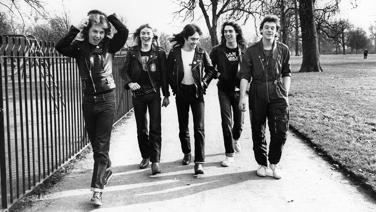 Dennis STRATTON and Steve HARRIS and Paul DI'ANNO and IRON MAIDEN and Dave MURRAY and Clive BURR; L-R: Clive Burr, Dave Murray, Steve Harris, Dennis Stratton, Paul Di'Anno - posed, group shot, walking through park 