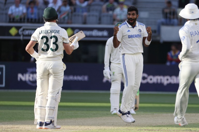 India's Jasprit Bumrah (C) celebrates with teammates during day three of the first Test cricket match between Australia and India at Optus Stadium in Perth on November 24, 2024. (Photo by COLIN MURTY / AFP) / -- IMAGE RESTRICTED TO EDITORIAL USE - STRICTLY NO COMMERCIAL USE --