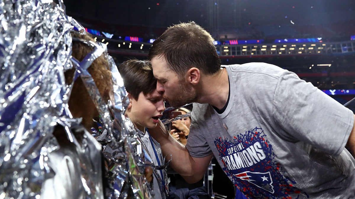 Brady kissing son