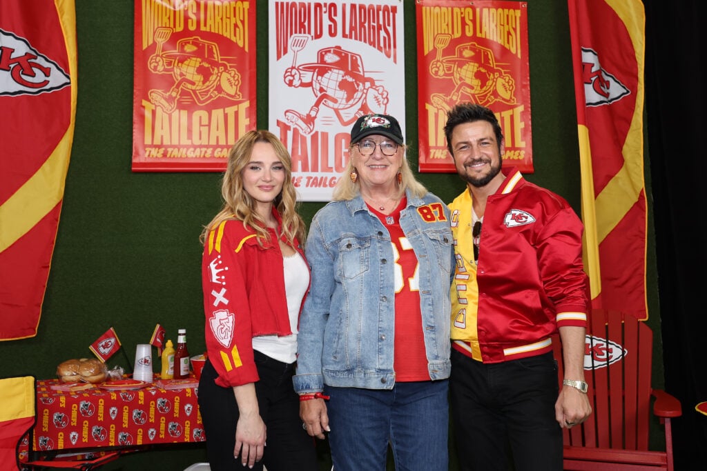 Hunter King, Donna Kelce and Tyler Hynes attend the red carpet at the "World's Largest Tailgate" ahead of the Baltimore Ravens v Kansas City Chiefs game at GEHA Field at Arrowhead Stadium on September 05, 2024 in Kansas City, Missouri. 