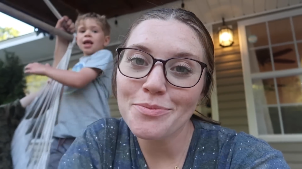 Joy-Anna Duggar wears glasses and faces the camera in a summer 2024 YouTube video.