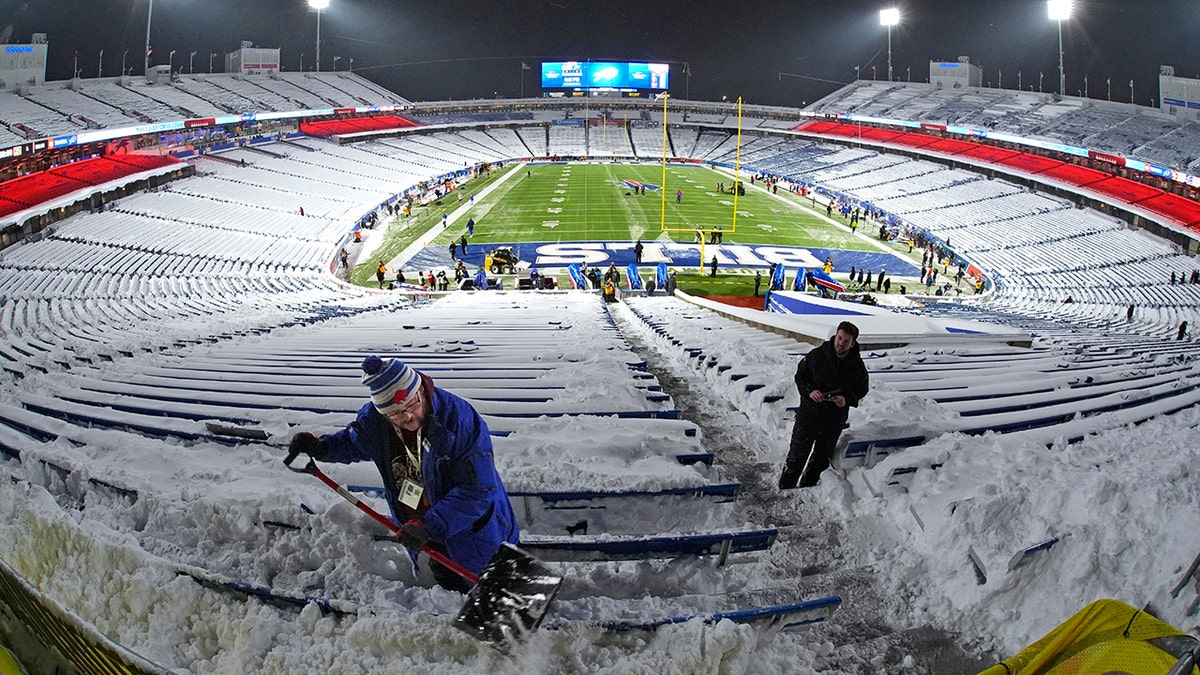 Workers clear snow