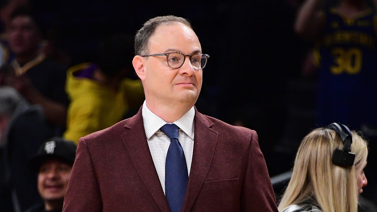 Adrian Wojnarowski looks on