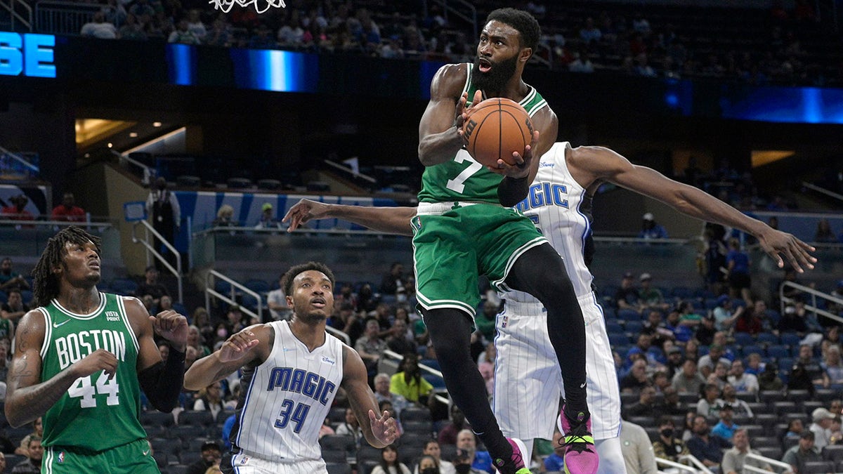 Boston Celtics guard Jaylen Brown (7) goes up for a shot in front of Orlando Magic center Wendell Carter Jr. (34) and center Mo Bamba, rear, as Celtics center Robert Williams III (44) watches during the second half of an NBA basketball game Wednesday, Nov. 3, 2021, in Orlando, Fla.