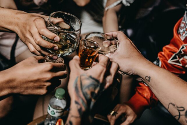 Different hands holding drinks