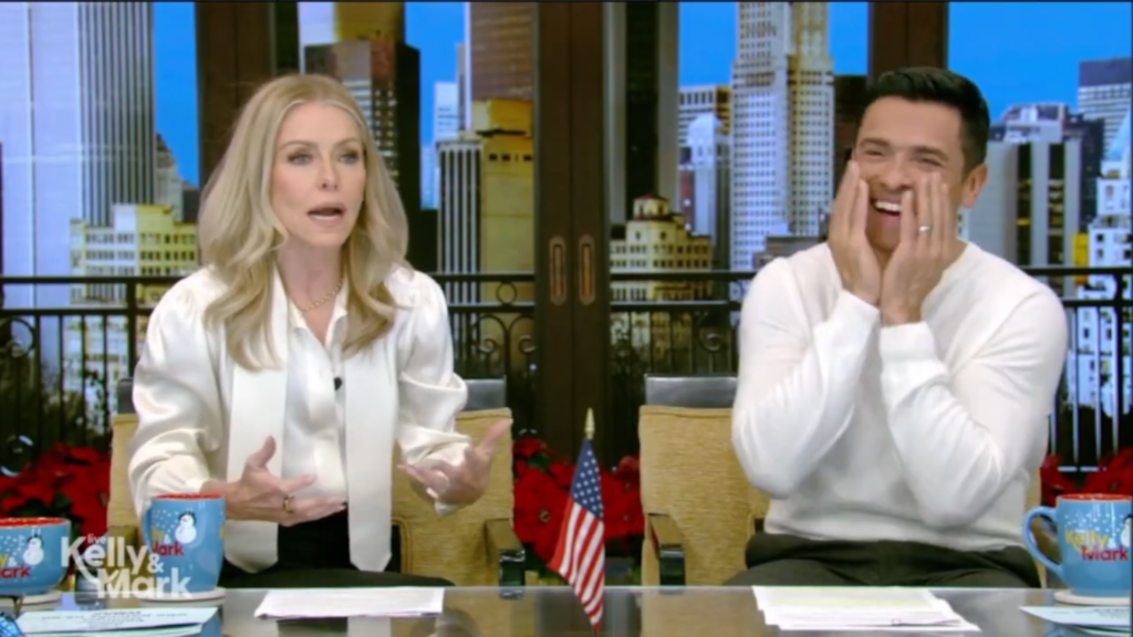 Mark Consuelos laughs as Kelly Ripa tells a story.