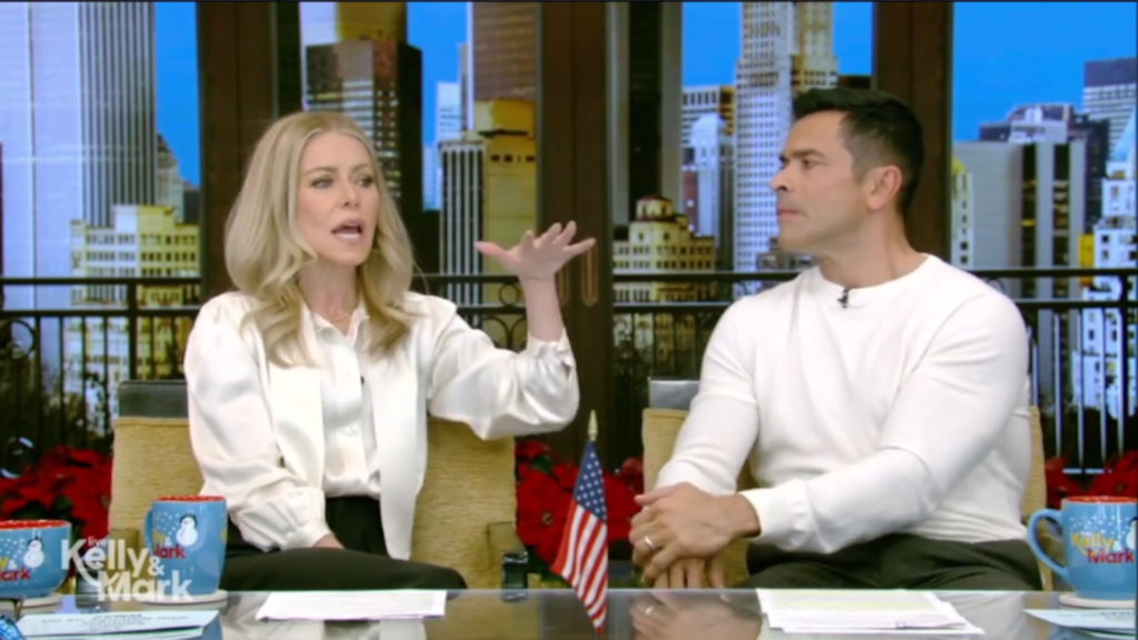 Kelly Ripa gestures beside Mark Consuelos.