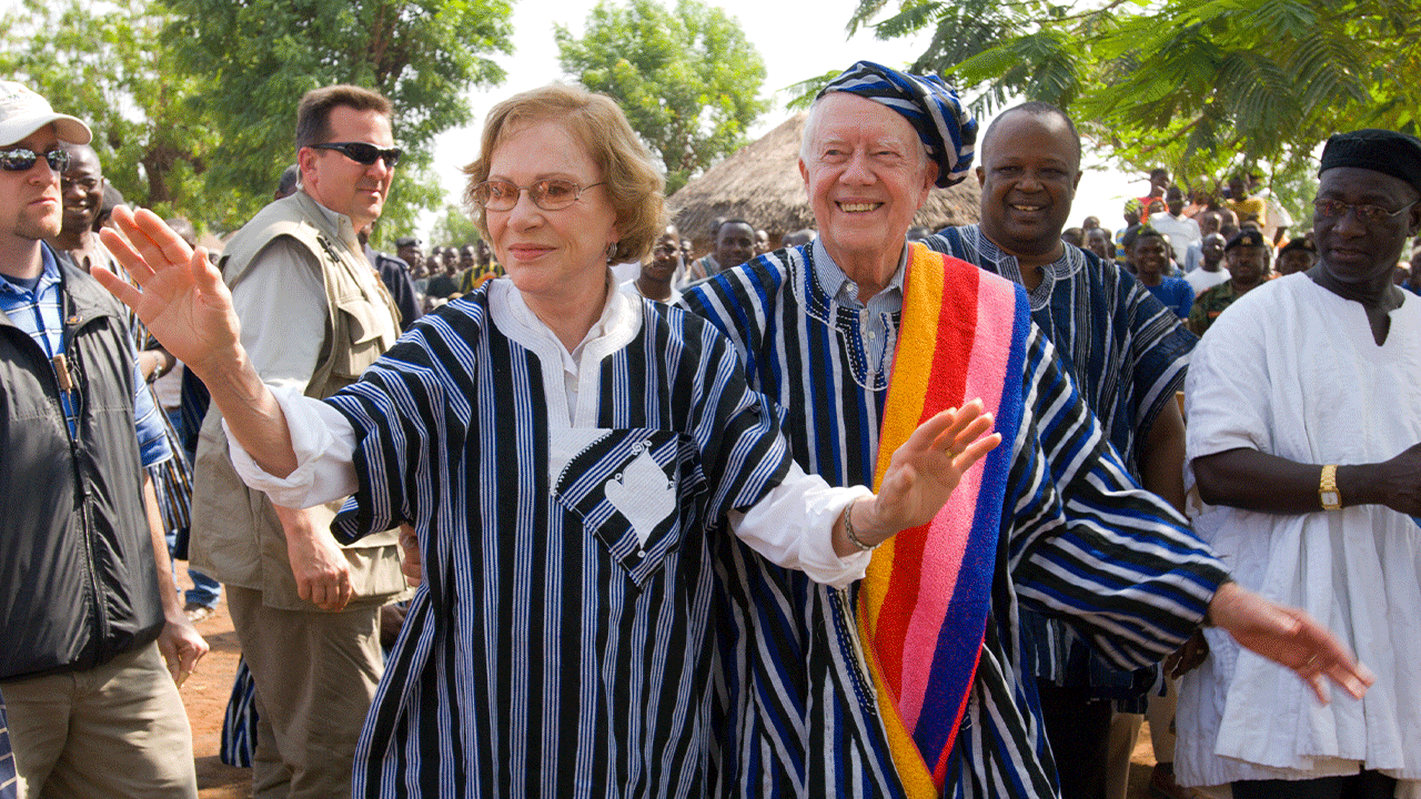 Former U.S. President Jimmy Carter and former First Lady Rosalynn Carter wear traditional Ghanaian attire, a gift from the chief of Tingoli village in northern Ghana, where The Carter Center, in partnership with Ghana's Ministry of Health, has worked to eradicate Guinea worm disease and eliminate trachoma.