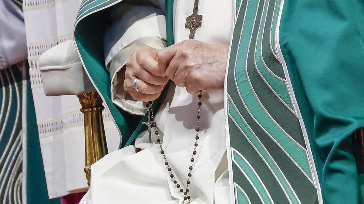 Pope Francis holding a rosary