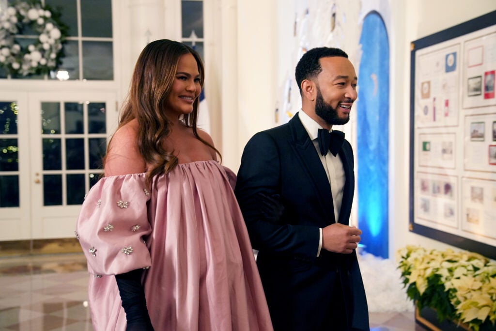 John Legend and Chrissy Teigen arrive for the White House state dinner for French President Emmanuel Macron at the White House on December 1, 2022 in Washington, DC. The official state visit is the first of the Biden administration.