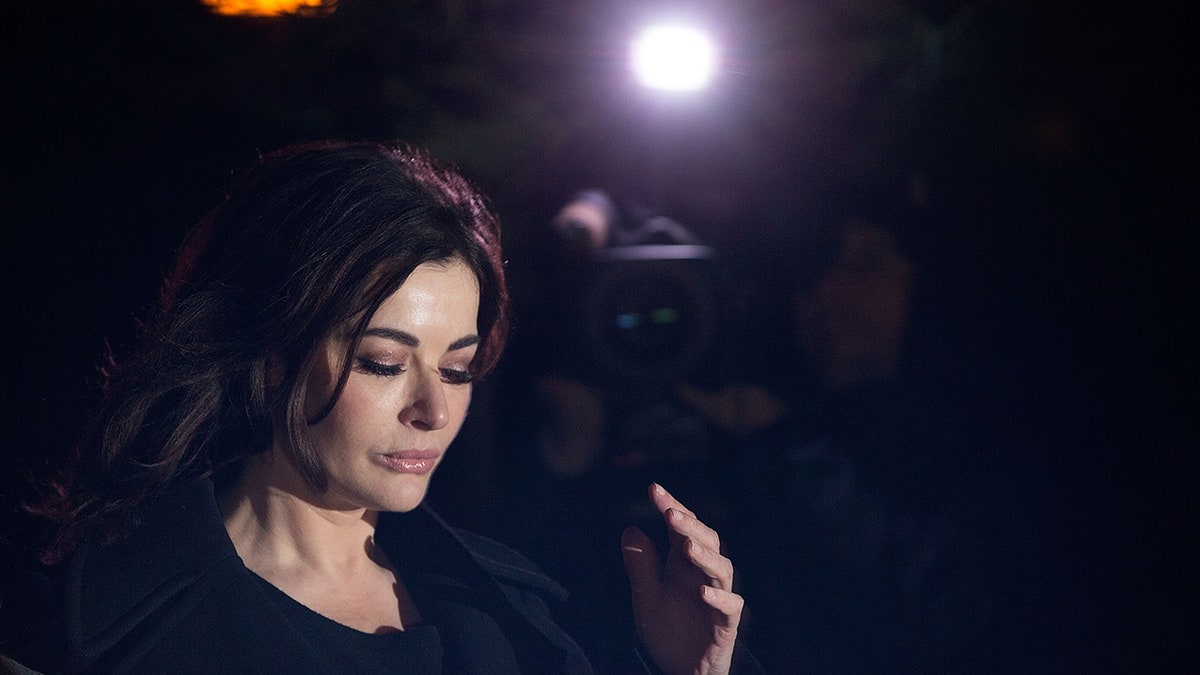 Nigella Lawson wearing black looking away from the camera.