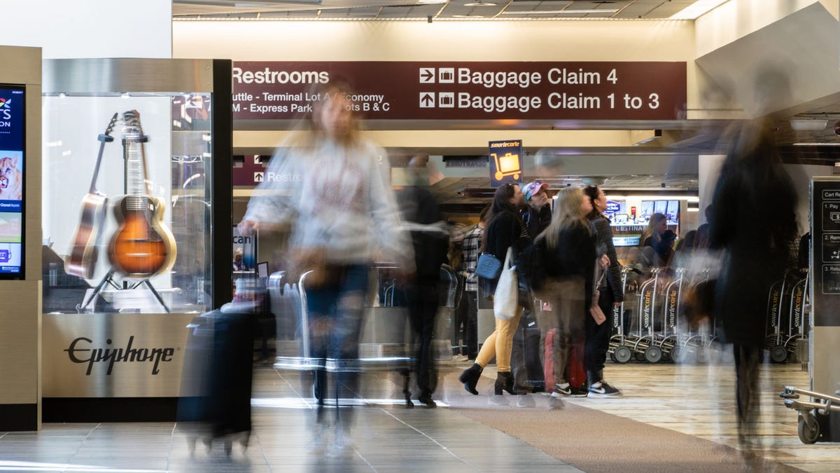 People in motion in the baggage claim area at Nashville International Airport (BNA)