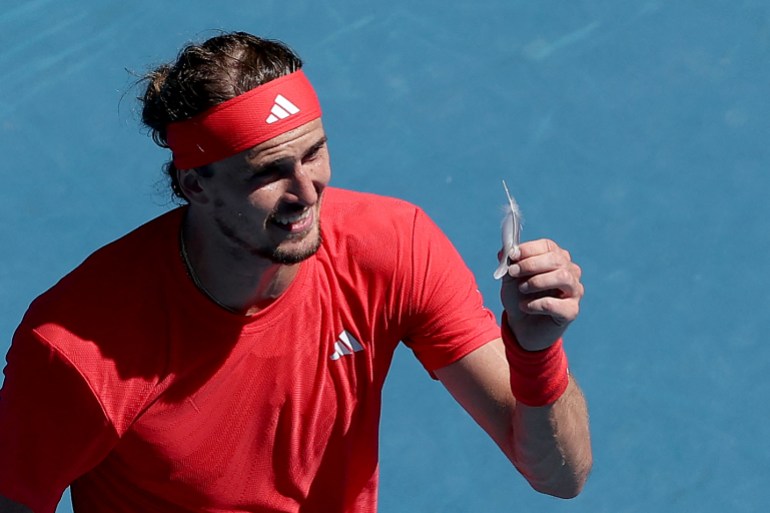 Germany's Alexander Zverev shows a feather to the umpire while arguing over a point during his men's singles quarterfinal match against the USA's Tommy Paul on day ten of the Australian Open tennis tournament in Melbourne on January 21, 2025. (Photo by Martin KEEP / AFP) / -- IMAGE RESTRICTED TO EDITORIAL USE - STRICTLY NO COMMERCIAL USE --