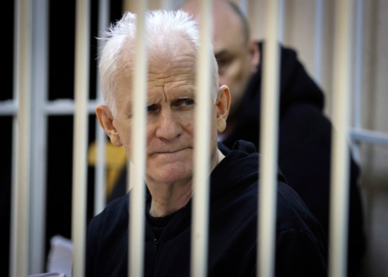 Ales Bialiatski, the head of Belarusian Vyasna rights group, sits in a defendants' cage during a court session in Minsk,