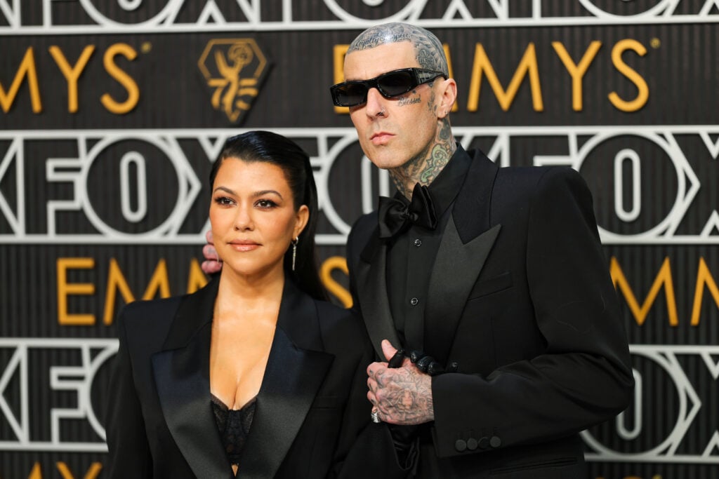 Kourtney Kardashian and Travis Barker pose on the red carpet at the 2024 Emmy Awards.