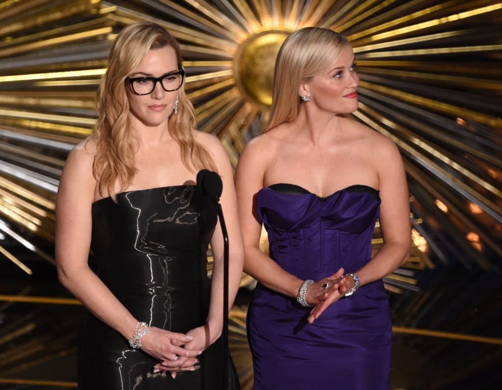 Kate Winslet and Reese Witherspoon present on stage at the 88th Oscars on February 28, 2016 in Hollywood, California.