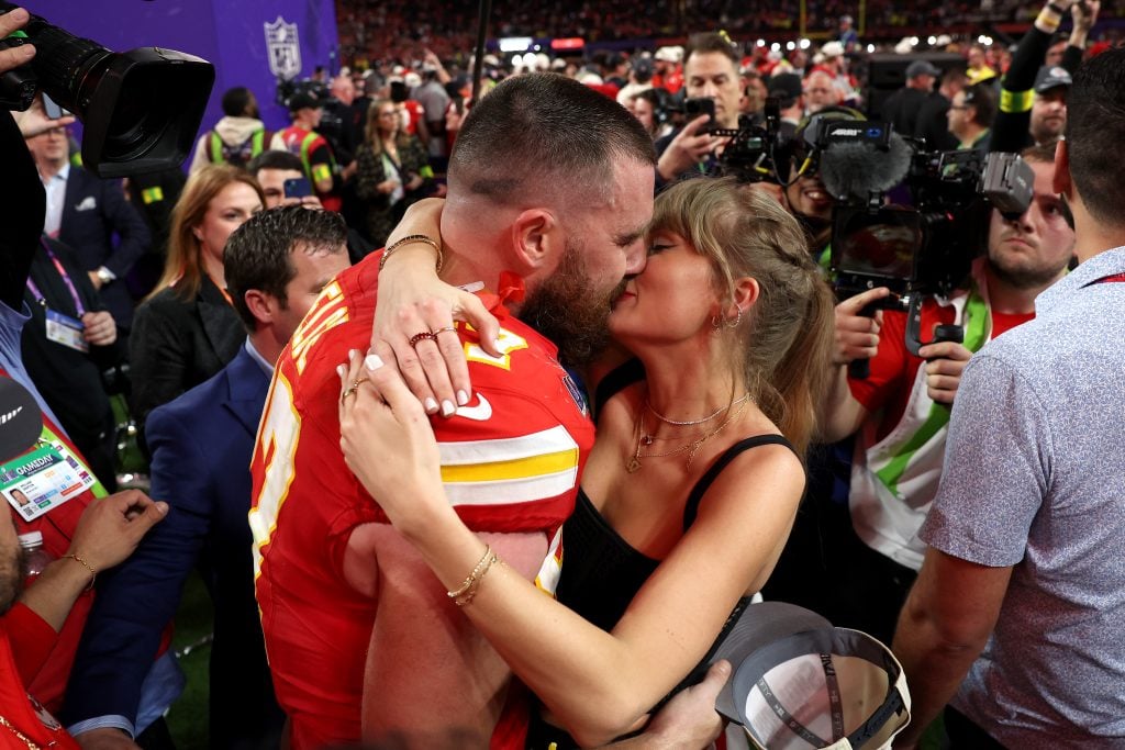 Travis Kelce and Taylor Swift kiss on February 11, 2024 following one of his sports games.