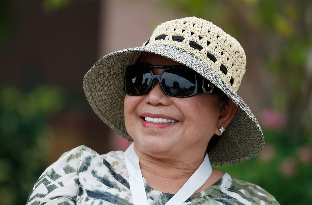 Kultida Woods waits near the clubhouse as her son Tiger Woods plays during the pro-am prior to the start of the Hero World Challenge at the Isleworth Golf & Country Club on December 3, 2014 in Windermere, Florida.