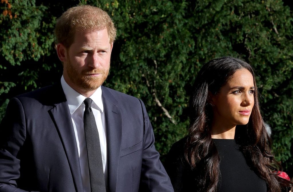 Prince Harry, Duke of Sussex, and Meghan, Duchess of Sussex on the Long Walk at Windsor Castle arrive to view flowers and tributes to HM Queen Elizabeth on September 10, 2022, in Windsor, England.