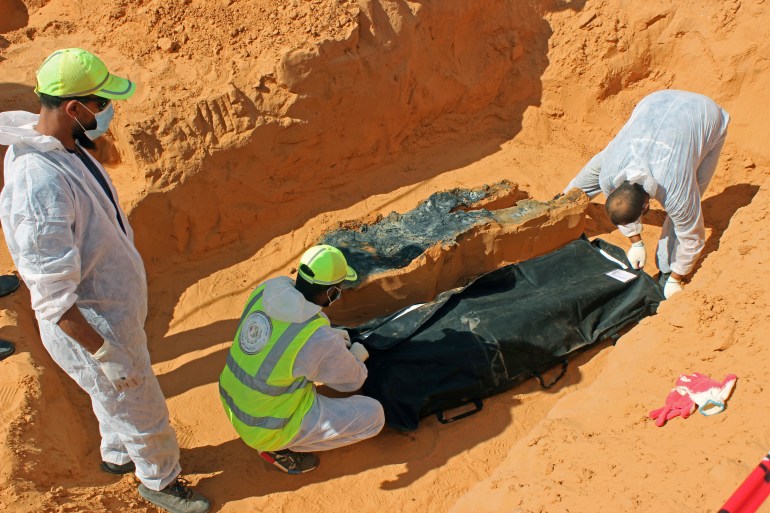 Members of the Government of National Accord's (GNA's) missing persons bureau, exhume bodies in what Libya's internationally recognized government officials say is a mass grave, in Tarhouna city, Libya October 27, 2020. Picture taken October 27, 2020. REUTERS/Ayman Al-Sahili