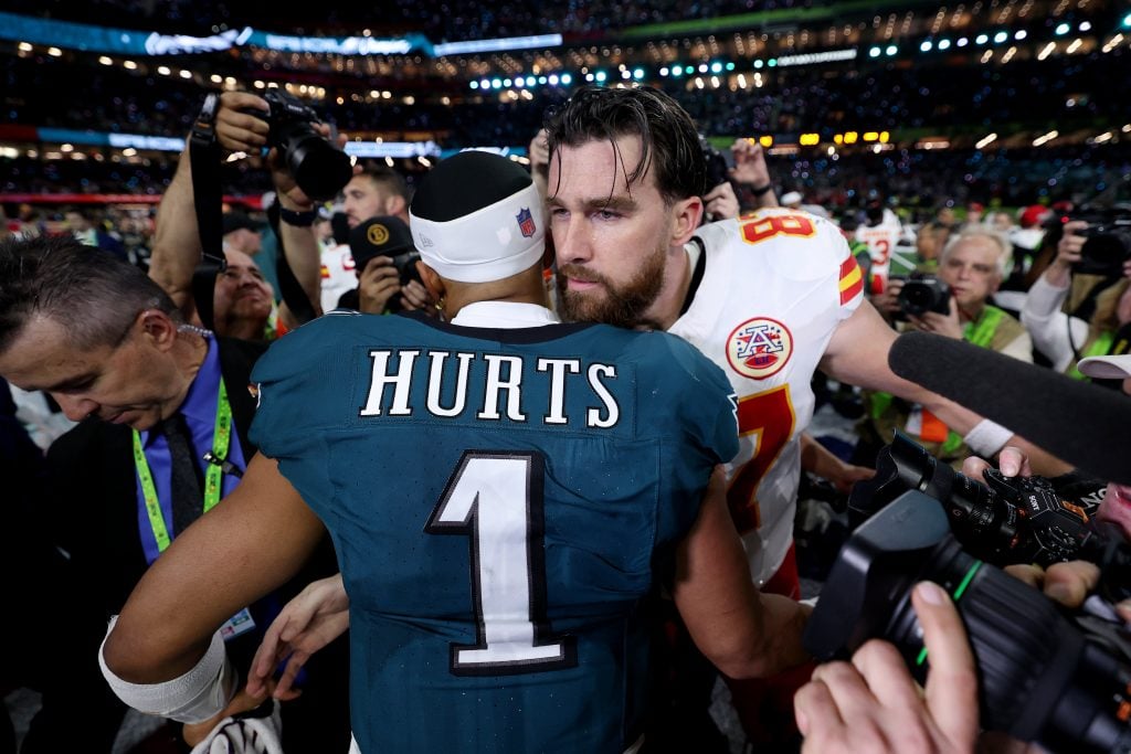 Jalen Hurts #1 of the Philadelphia Eagles and Travis Kelce #87 of the Kansas City Chiefs meet after Philadelphia beat Kansas City 40-22 to win Super Bowl LIX at Caesars Superdome on February 09, 2025 in New Orleans, Louisiana.