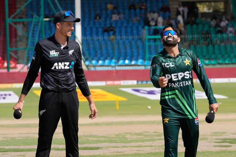 Pakistan's Mohammad Rizwan, right, flips the coin for toss as New Zealand's Mitchel Santner watches before start of the tri-series ODI cricket final match between Pakistan and New Zealand, in Karachi, Pakistan, Friday, Feb. 14, 2025. (AP Photo/Fareed Khan)