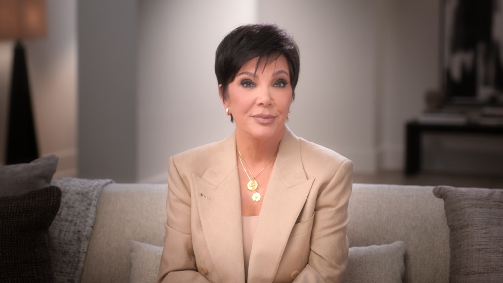 Kris Jenner wears a cream ensemble while speaking to the confessional camera for The Kardashians.