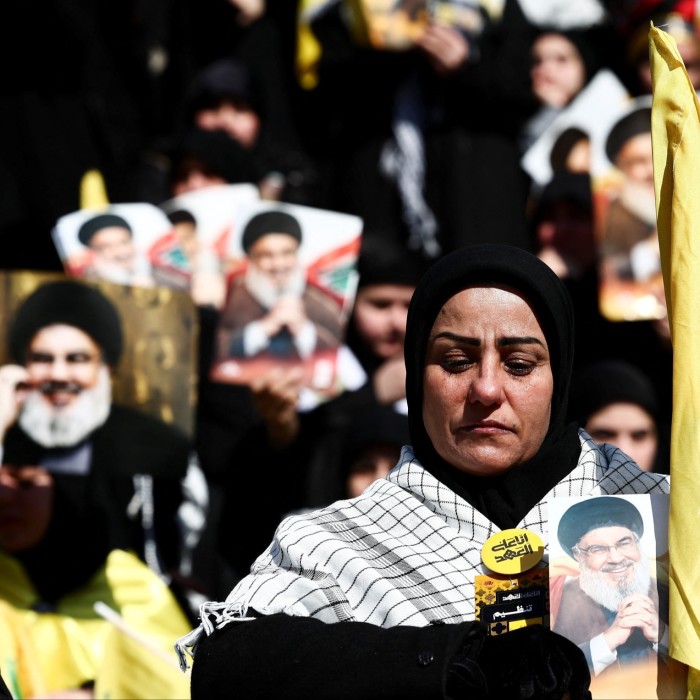 A mourner reacts on the day of a public funeral ceremony for late Hizbollah leaders Hassan Nasrallah and Hashem Safieddine