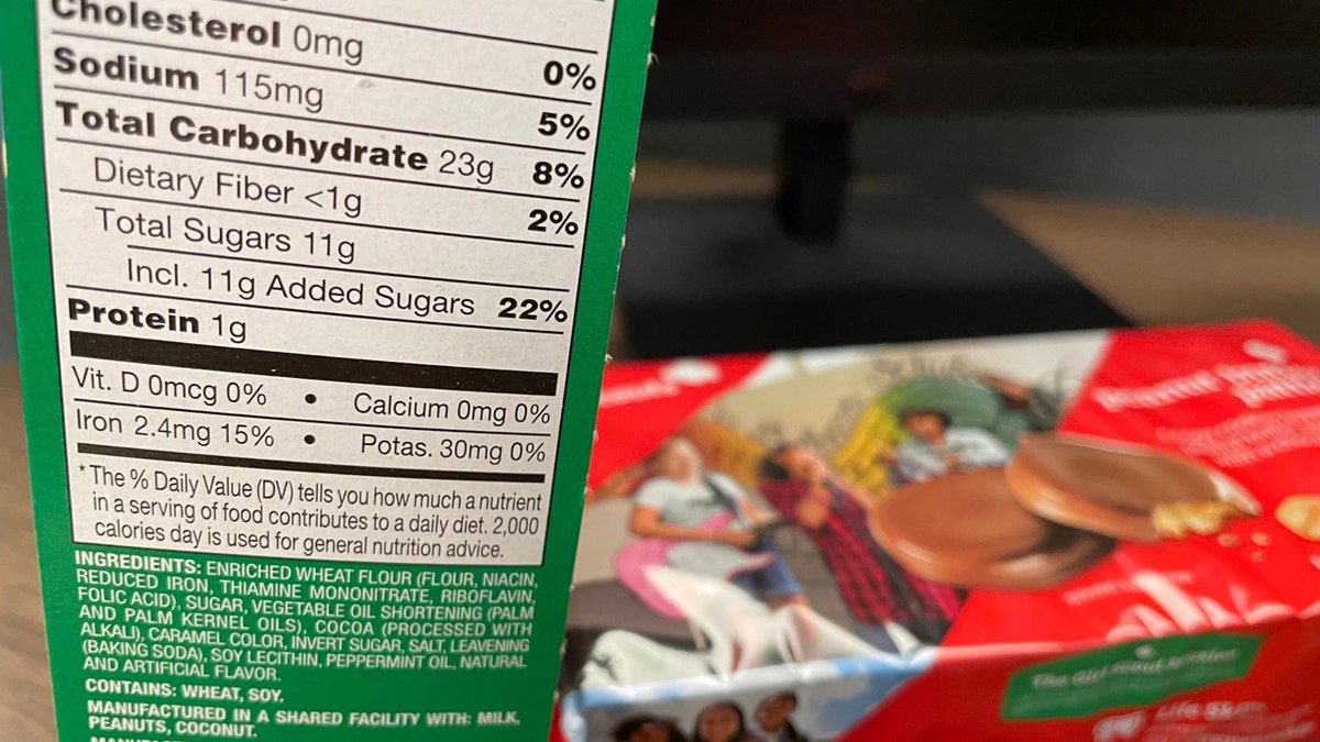 An ingredient label for Thin Mints is shown while a package of Peanut Butter Patties is seen in the background.