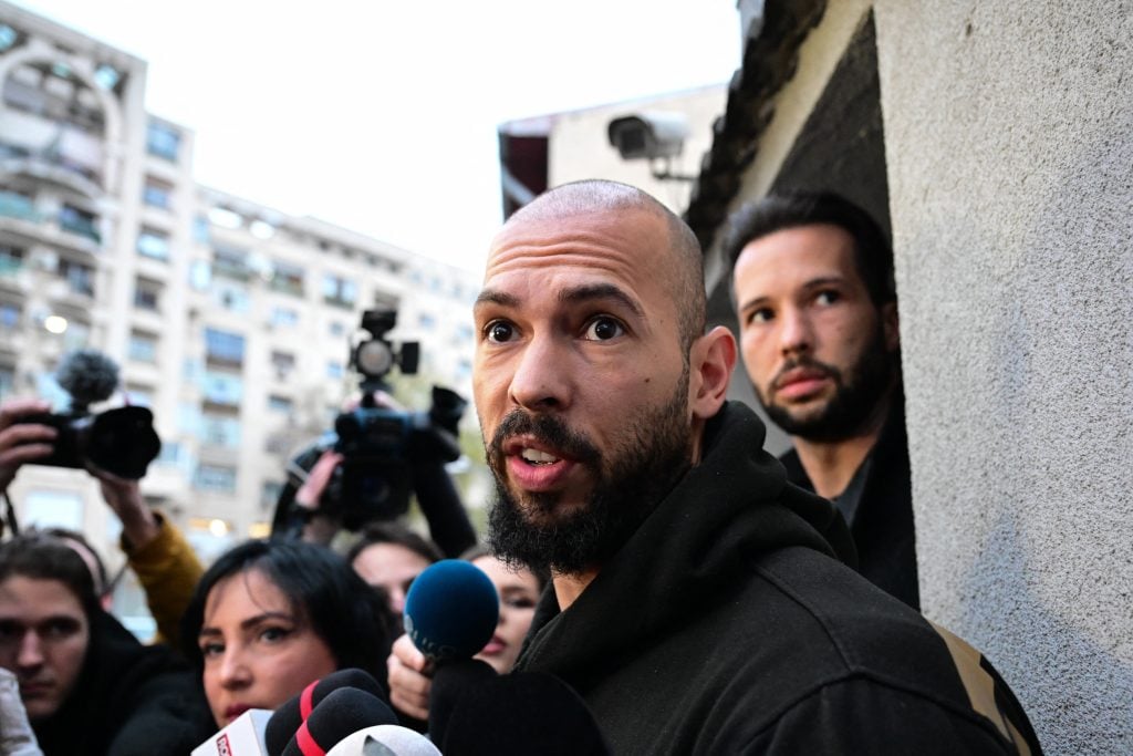 British-US former professional kickboxer and controversial influencer Andrew Tate (front) and his brother Tristan Tate (back R) speak to journalists after having been released from detention in Bucharest, Romania on March 12, 2024. 