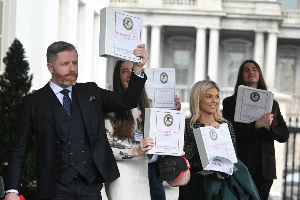 Political commentator Rogan O'Handley, aka DC Draino, TikToker Chaya Raichik, commentator Liz Wheeler and US conservative activist Scott Presler carry binders bearing the seal of the US Justice Department reading "The Epstein Files: Phase 1" as they walk out of the West Wing of the White House in Washington, DC, on February 27, 2025.