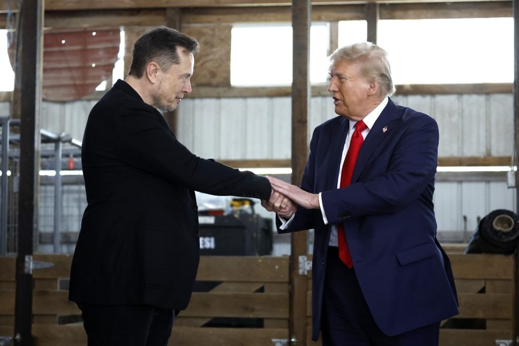 Elon Musk shakes hands with Republican presidential nominee, former President Donald Trump backstage during a campaign rally at the Butler Farm Show grounds on October 05, 2024 in Butler, Pennsylvania.