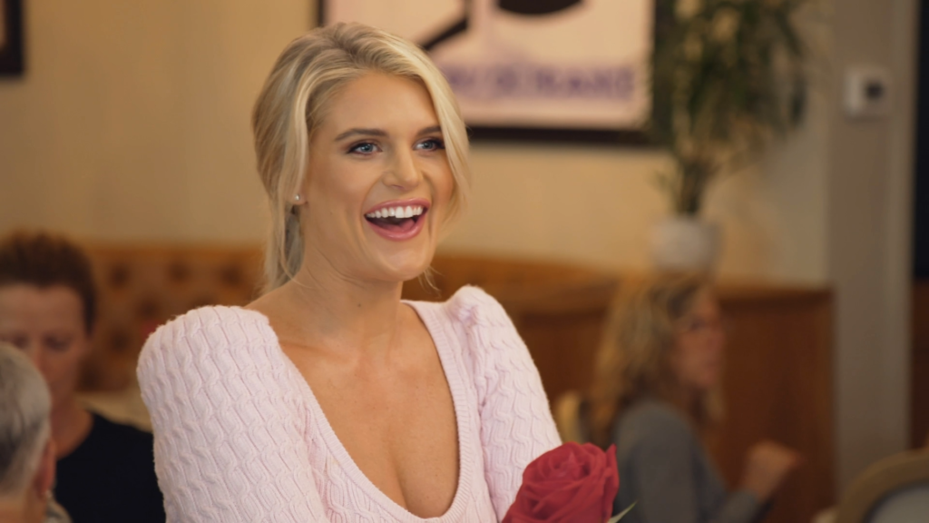 Flashing a smile in a powder pink blouse, Madison LeCroy goes out to eat.