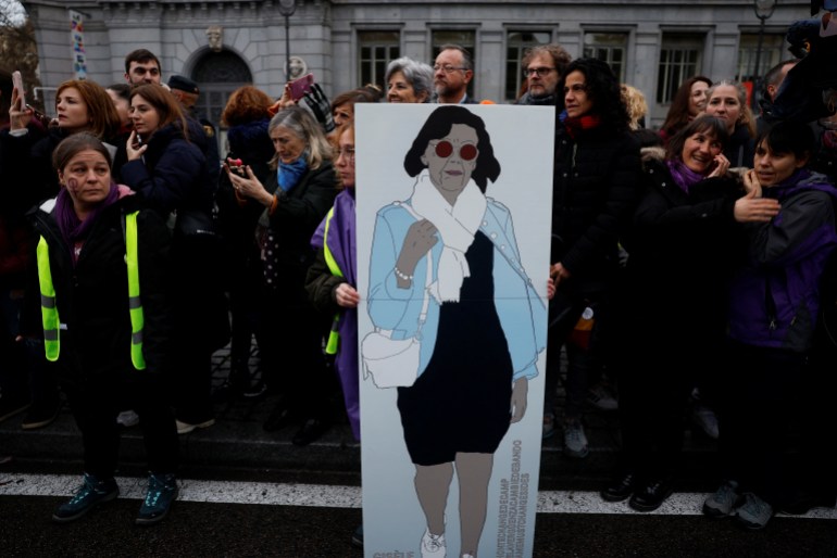 A woman holds a poster honouring Gisele Pelicot, the victim of a mass rape orchestrated by her then-husband Dominique Pelicot, during a demonstration to mark International Women's Day in Madrid, Spain, March 8, 2025. REUTERS/Susana Vera