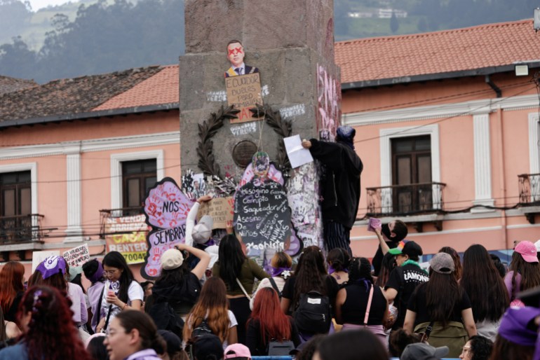 Placards and a cutout depicting Ecuador's President Daniel Noboa are attached to a monument as demonstrators march to mark International Women's Day, in Quito, Ecuador March 8, 2025. REUTERS/Karen Toro