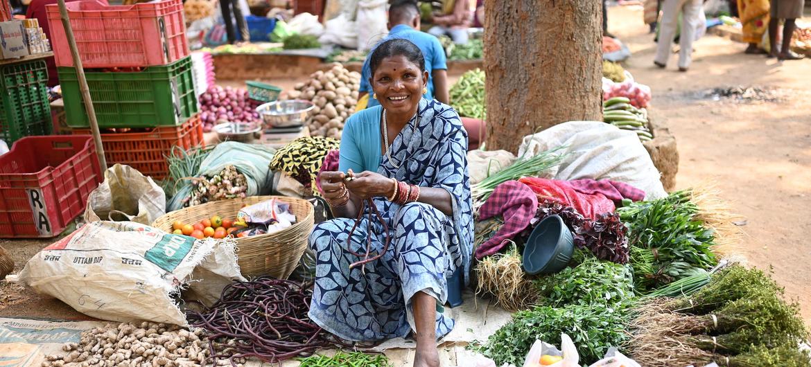 A woman sells forest produce at a local market in India.