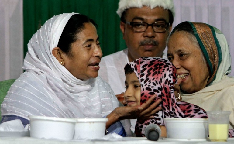 Chief Minister of West Bengal state Mamata Banerjee, left, talks with a Muslim girl and her grandmother during an Iftar, the meal that breaks the Ramadan fast, in Kolkata, India, Friday, Aug. 12, 2011. Muslims around the world are marking the holy fasting month of Ramadan, where the devout fast from dawn until dusk. (AP Photo/Bikas Das)