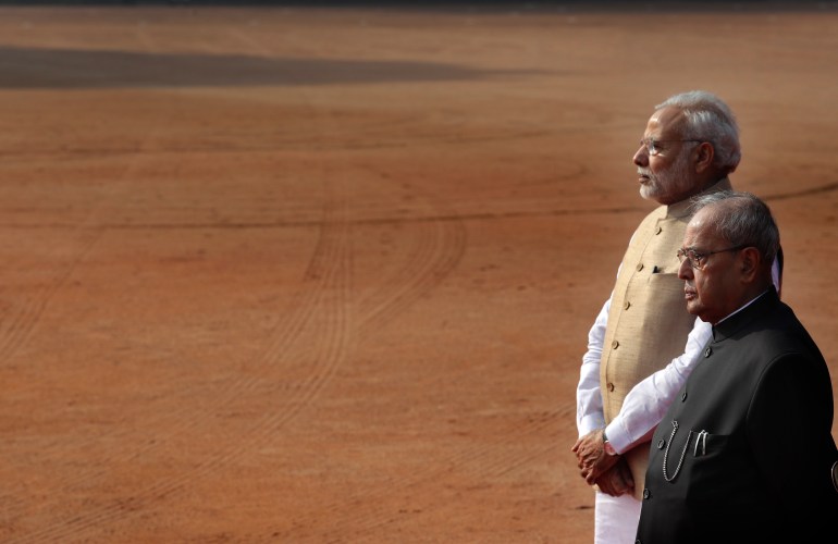 Indian President Pranab Mukherjee, right, with Indian Prime Minister Narendra Modi, wait for the arrival of visiting Indonesian President Joko Widodo at the Indian presidential palace in New Delhi, India, Monday, Dec. 12, 2016. (AP Photo/Manish Swarup)