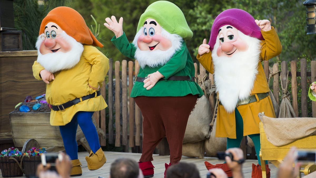 Disney characters (L-R) Doc, Happy Dwarf and Sleepy Dwarf can be seen at Walt Disney World Resort in Lake Buena Vista, Florida. For the 2025 remake, the film generated controversy over how the dwarf characters would be portrayed.