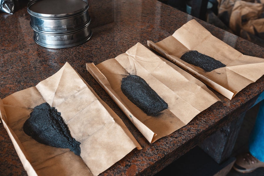 Graphite samples on brown paper on a counter